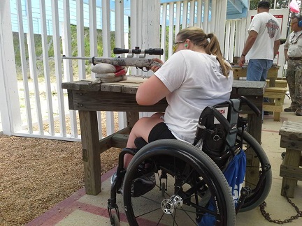 wheelchair user takes aim with rifle